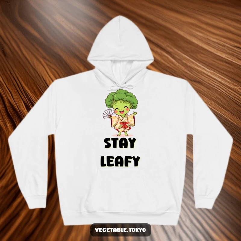 Funny hoodie featuring a joyful broccoli in a patterned kimono, performing a fan dance, offering snug comfort and artistic humor.